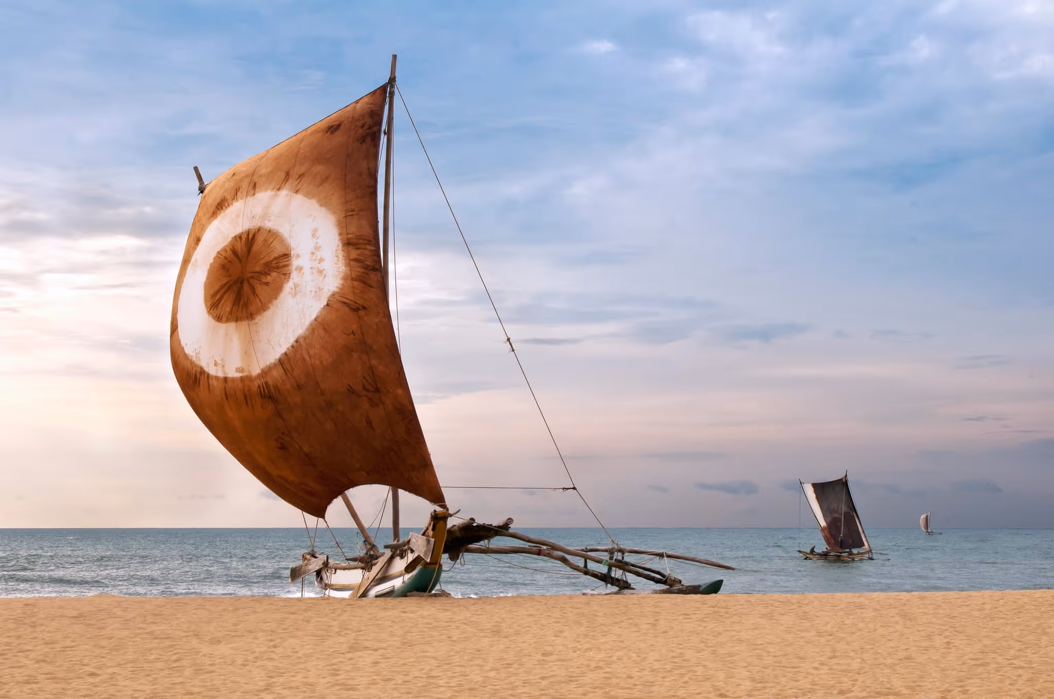 A sailboat cruising along Sri Lanka’s southern coastline at sunset